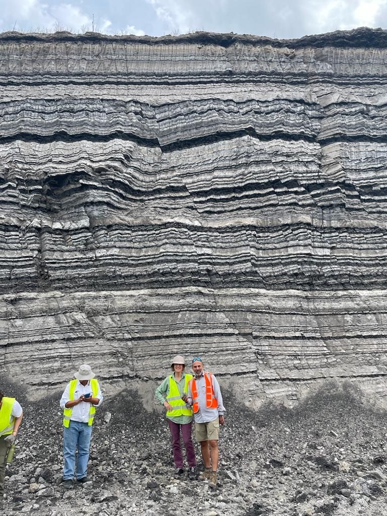 Examination of layered organic-rich sediments by TSOP members on the post conference field trip in September 2023, Greece (Photograph courtesy of Joan Esterle)